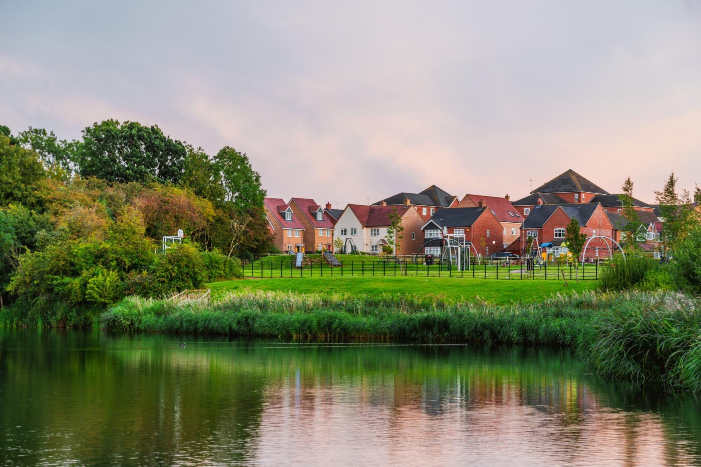 Milton Keynes, UK houses and playground by water.