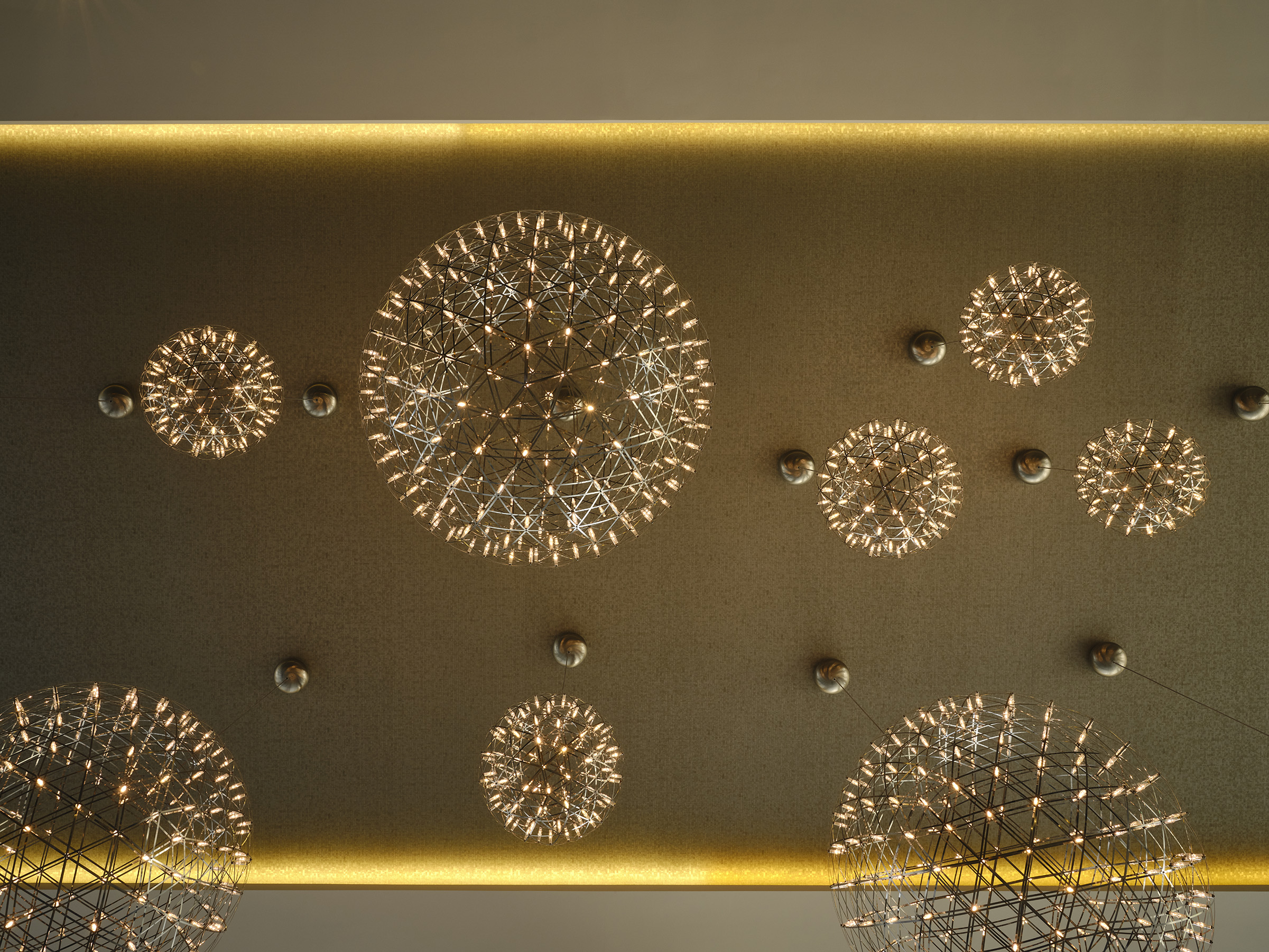 Modern spherical ceiling lights illuminate a textured ceiling.