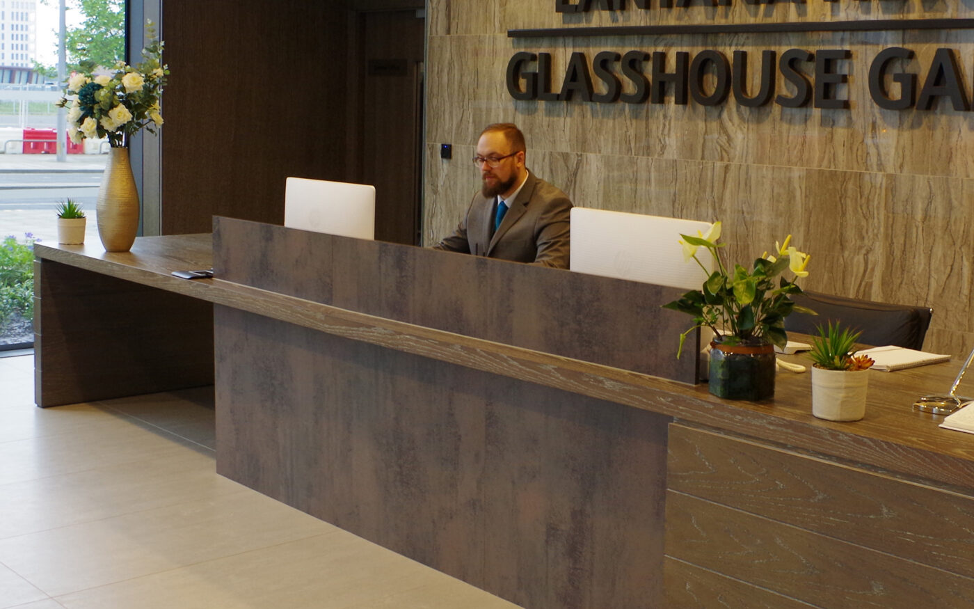 Customer service representative at reception desk.