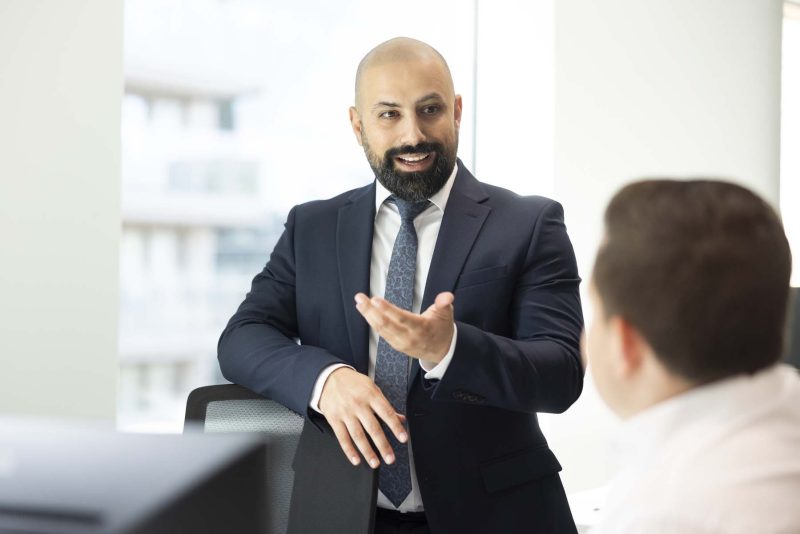 Businessman in suit discussing work with a colleague.