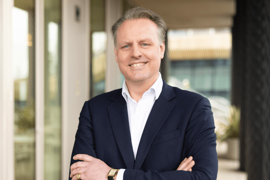 Portrait of Martin King, arms crossed.