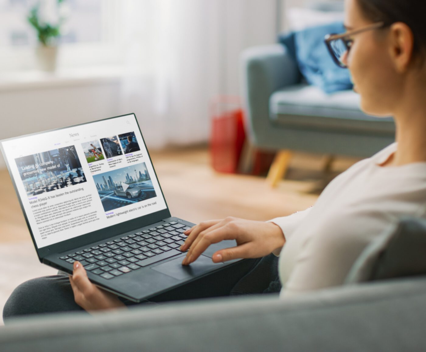 Person using laptop, reading online news articles.