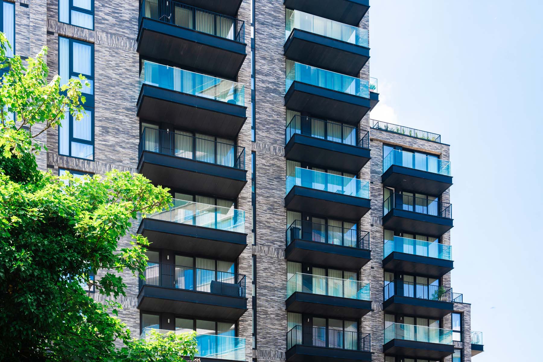 Exterior of modern apartment building with balconies.