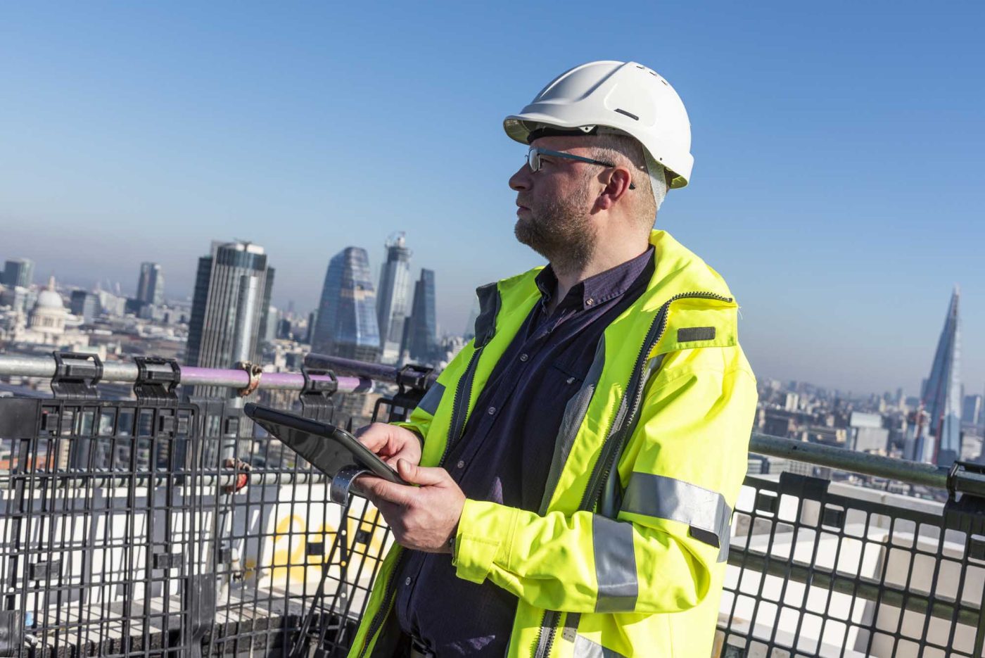 Architect using tablet on London construction site.