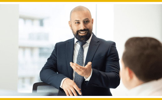 Businessman in suit gesturing during a meeting.