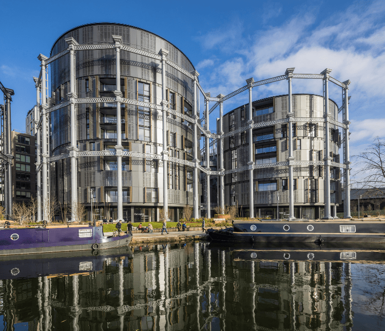 Modern apartment buildings built into repurposed gasholders.