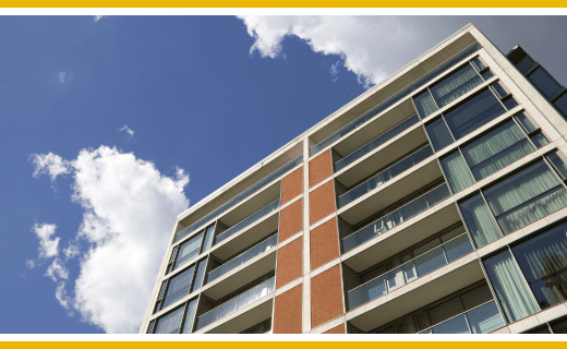 Modern apartment building against a blue sky.