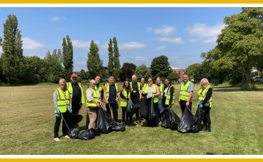 Group of volunteers litter picking in a park.