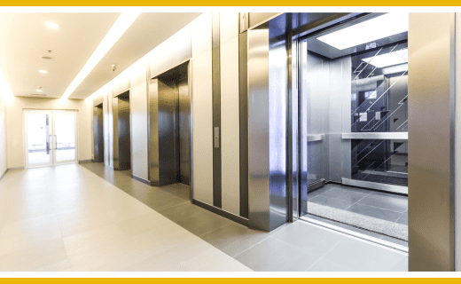 Modern building hallway with multiple elevators.