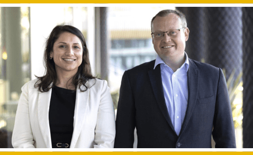 Portrait of two people in business attire.