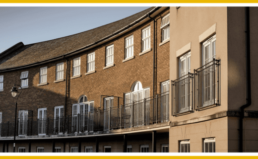 Curved row of brick apartment buildings with balconies.