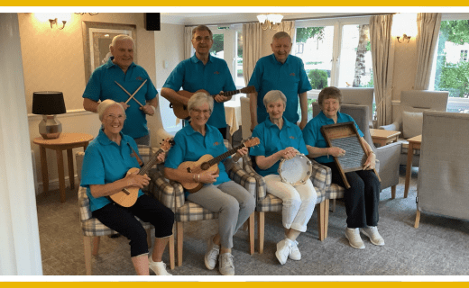 Senior residents playing ukuleles, tambourine, and washboard.